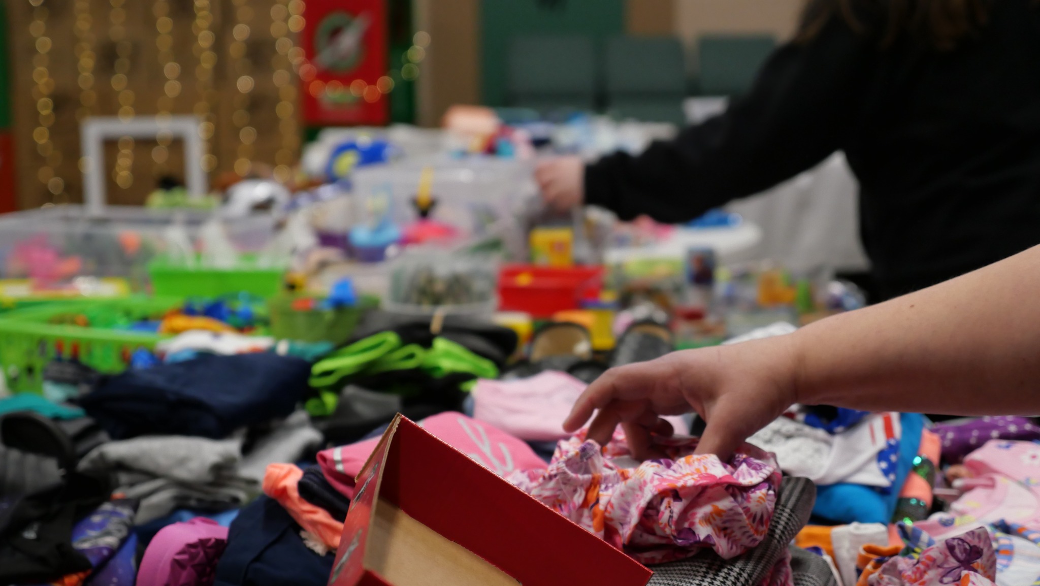 Volunteers at Life of Faith Gospel Ministries sorting clothing and care items for Brampton community members